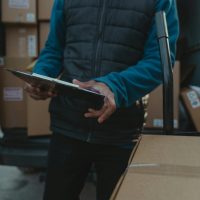 Professional medical courier driver loading secure medical supplies into a delivery van in the UK